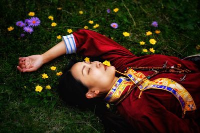 Portrait of girl lying on field