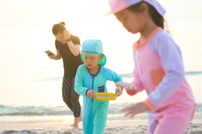 Boy and girl playing on beach