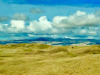 Scenic view of landscape against blue sky