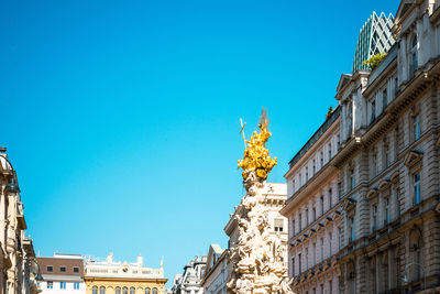 High section of built structures against clear blue sky