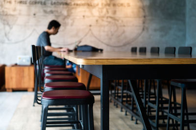 Side view of man sitting on table
