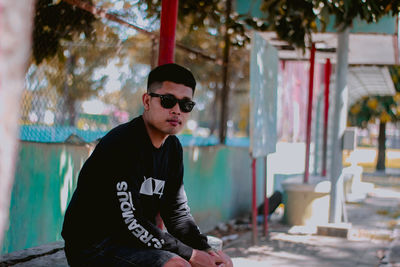 Young man wearing sunglasses standing outdoors