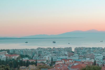 High angle view of townscape by sea against sky