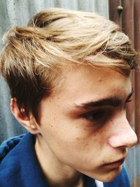 Close-up of thoughtful teenage boy looking away