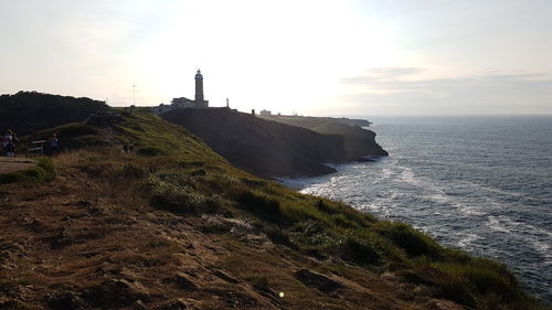Scenic view of sea by buildings against sky