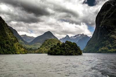 Scenic view of mountains against cloudy sky