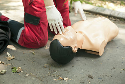 Low section of woman applying cpr on dummy