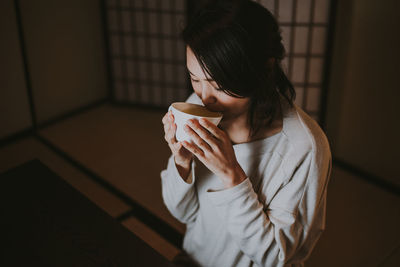 Woman holding coffee cup