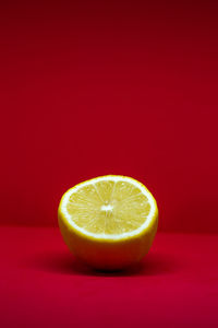 Close-up of lemon slice against red background