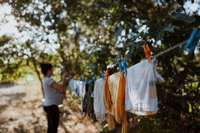 Side view of woman drying clothes