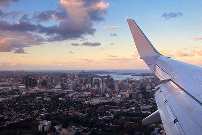 Aerial view of city against sky during sunset / flying over sydney