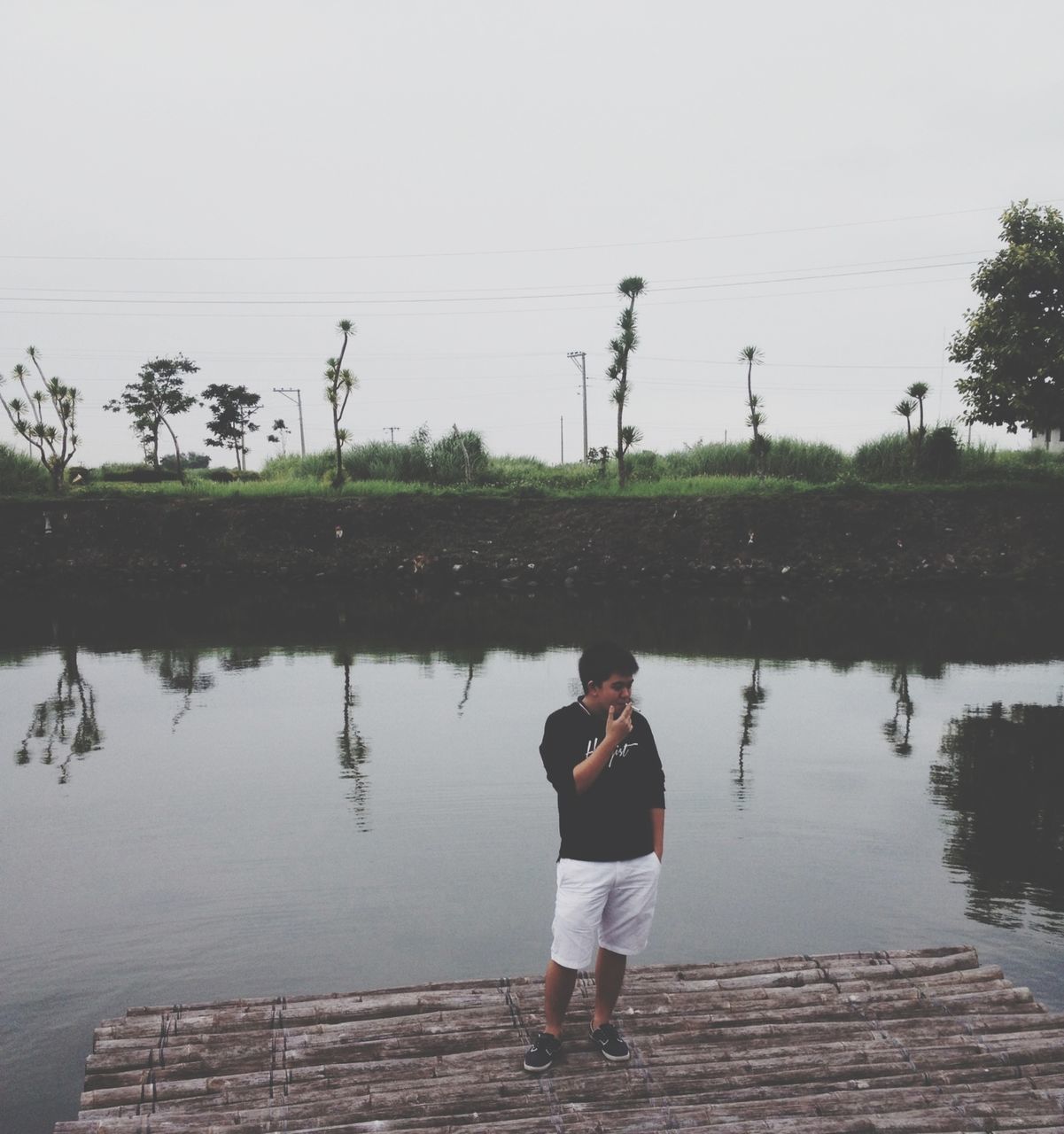 water, rear view, lifestyles, full length, standing, leisure activity, lake, casual clothing, reflection, tree, person, sky, men, walking, river, nature, tranquility, day