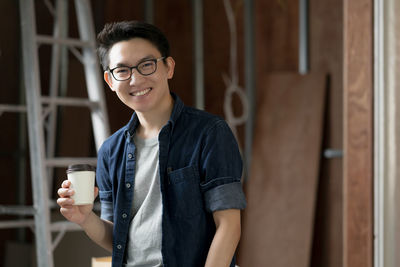 Portrait of young man drinking coffee