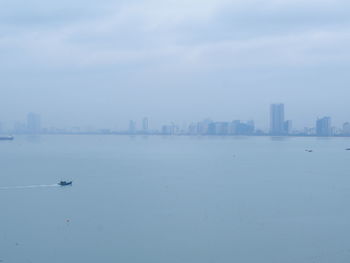 Scenic view of sea and buildings against sky