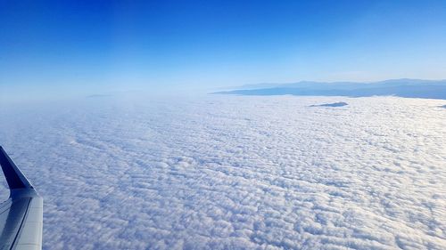 Scenic view of snowcapped mountains against blue sky