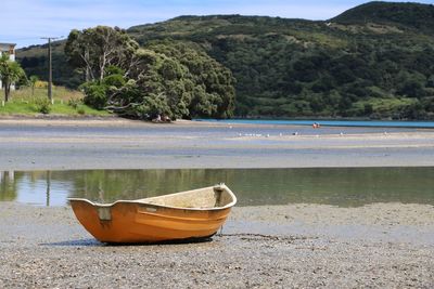 Boat on lake against trees