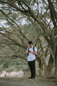 Side view of young man standing on land