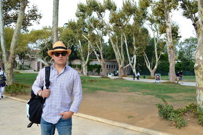 Man wearing hat while standing in park