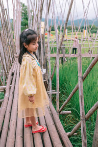 Portrait of young woman standing in forest