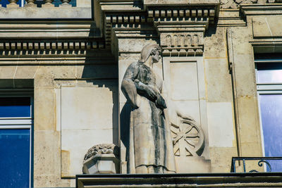 Low angle view of statue against building