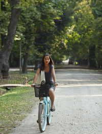 Woman riding bicycle at public park