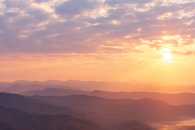 Scenic view of silhouette mountains against sky during sunset