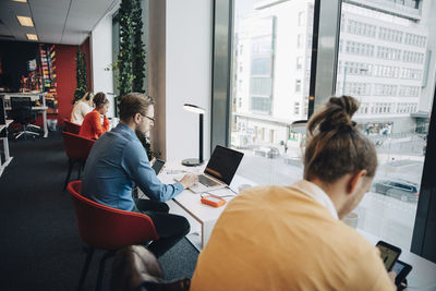 Multi-ethnic business people working at desk in office