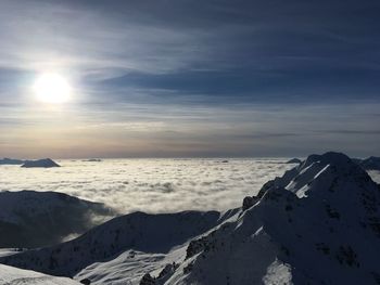 Scenic view of snow covered mountains against sky