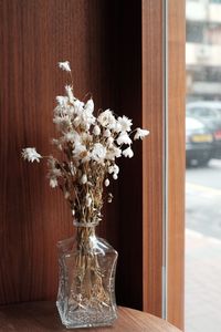 Close-up of flower vase on table at home