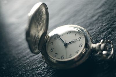 Close-up of clock on table