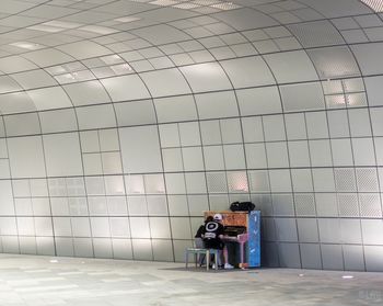 Rear view of people walking on floor in building