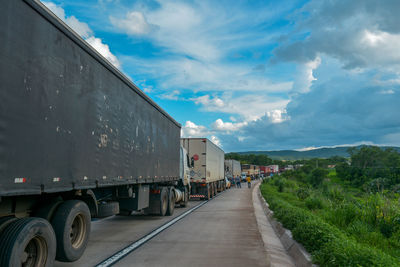 Truck congestion on the highway in the late afternoon and a beautiful blue sky. 
