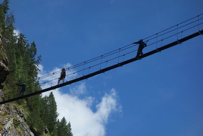 Low angle view of bridge against blue sky