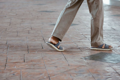 Low section of man walking on floor