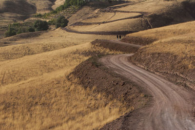 High angle view of dirt road on land