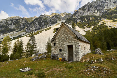 Traditional building by mountains against sky