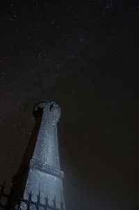 Low angle view of illuminated light against sky at night