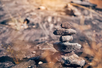 Close-up of stack of stones on field