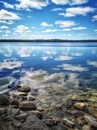 Scenic view of lake against blue sky