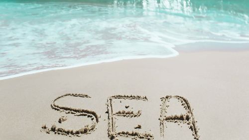 Text on sand at beach