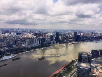 Cityscape against cloudy sky