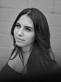 Portrait of beautiful woman against wall