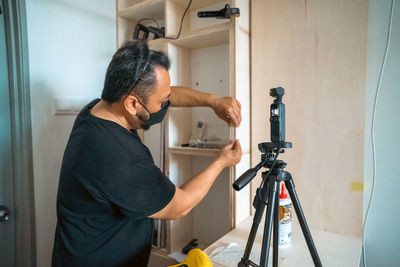 Side view of man working at home