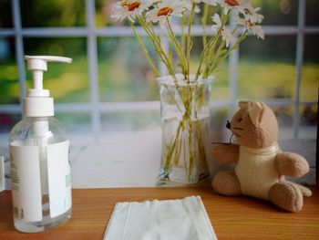 Close-up of flowers in vase on table at home