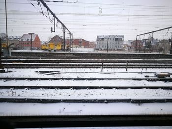 View of railroad tracks in city during winter