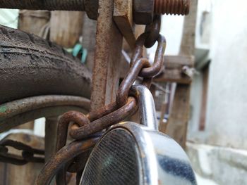 Close-up of lock hanging on rusty chain