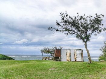 Hut on field against sky