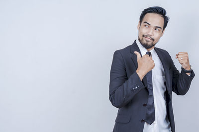 Portrait of a smiling young man against white background