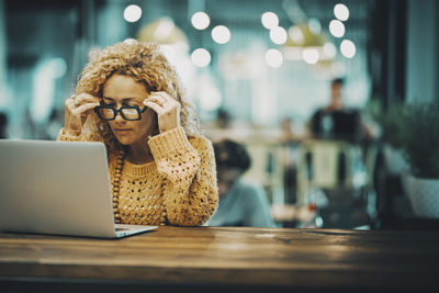 Young woman using laptop at table