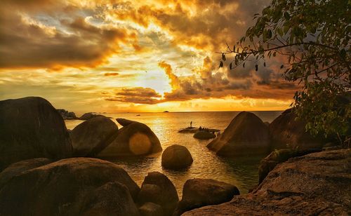 Scenic view of beach against sky during sunset